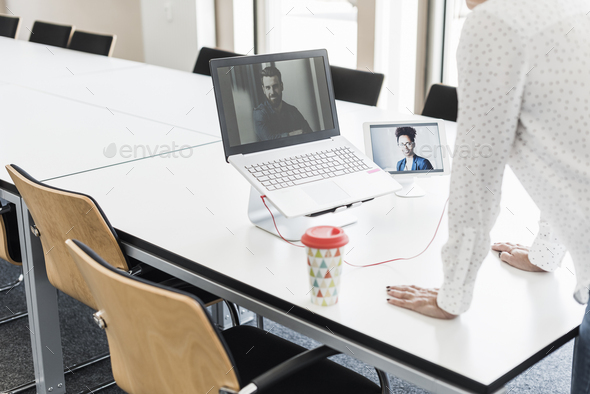 Businesswoman having a video conference in office - Stock Photo - Images