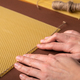 Making candle from Beeswax honeycomb sheet on brown background - PhotoDune Item for Sale
