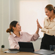 Two happy successful female managers giving high five for celebrating success. - PhotoDune Item for Sale