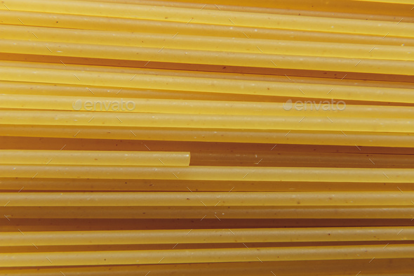 Raw long spaghetti macro photo, background. Raw spaghetti wallpaper