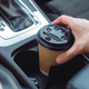 Man take Paper Cup from cup holder in car. Hot drink to take away with you on the road. - PhotoDune Item for Sale