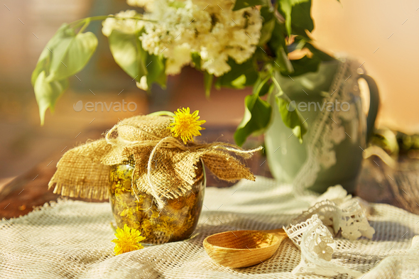 Homemade herbal organic dandelion tincture with wild flowers. Dandelion root tincture recipe