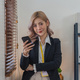 Smiling businesswoman using phone in office. business entrepreneur looking at her mobile phone and - PhotoDune Item for Sale
