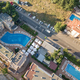 Top down aerial view of hotels roofs, streets with parked cars and swimming pools - PhotoDune Item for Sale