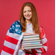 American woman student holds stack of university books from library on pink - PhotoDune Item for Sale