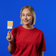 Young blonde woman artist with brush on blue background. Creative person. - PhotoDune Item for Sale