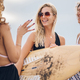Three beautiful woman friends posing with surfboard on a beach - PhotoDune Item for Sale