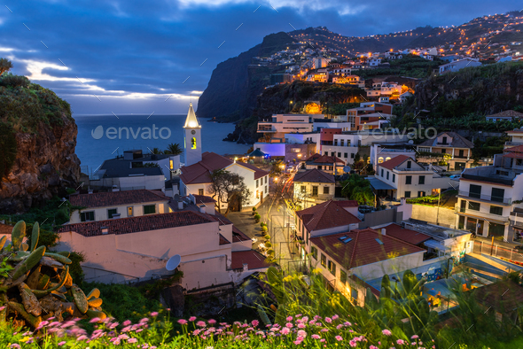 Cityscape of Camara de Lobos at dusk illuminated architecture of the seaside town in Madeira  - Stock Photo - Images