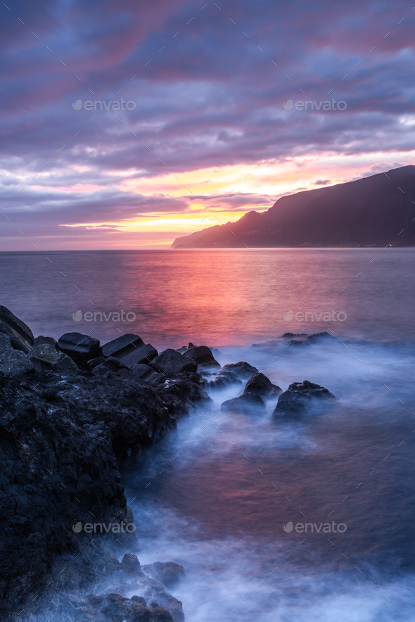 Beautiful sunrise over Madeira Seixal beach. Cliffs and rocks and atlantic ocean  - Stock Photo - Images