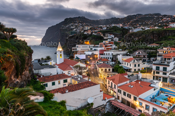 Cityscape of Camara de Lobos at dusk illuminated architecture of the seaside town in Madeira island - Stock Photo - Images