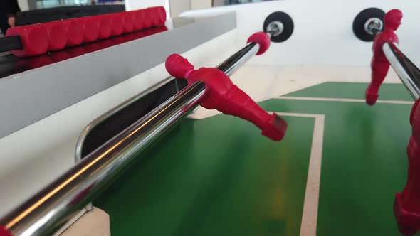 Close up footage of a table football game, also known as foosball