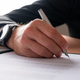 Hand of a businessman with elegant watch on his wrist signing a document - PhotoDune Item for Sale