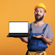 Cheerful builder showing laptop with white blank screen - PhotoDune Item for Sale