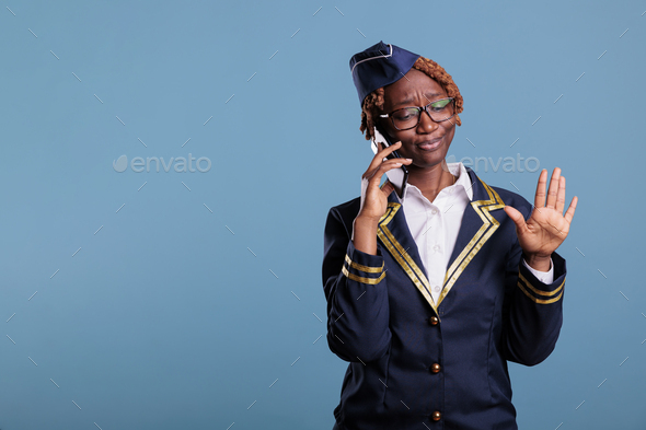 Stewardess looks annoyed while using mobile device - Stock Photo - Images