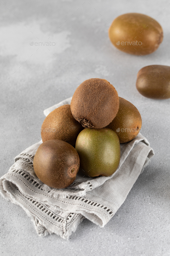 Golden, red and green kiwi fruit on a gray table. Different types of ripe kiwi. - Stock Photo - Images
