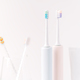 Plastic and electric toothbrushes with toothpaste against white background - PhotoDune Item for Sale
