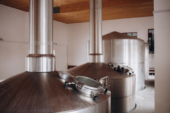 Brewery equipment. Brew manufacturing. Round cooper storage tanks for beer fermentation