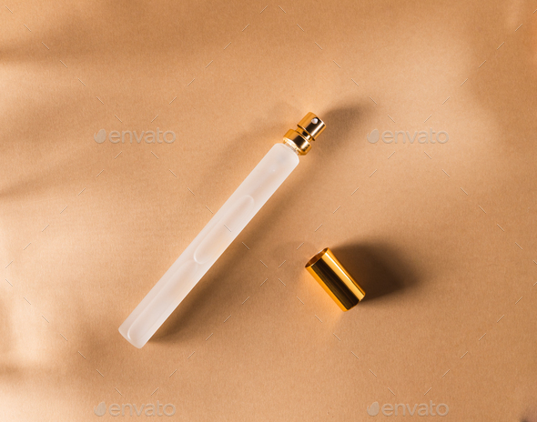 15 ml travel perfume or fragrance bottle on craft background. Top view. - Stock Photo - Images