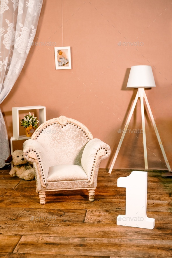 Little children's room interior in photo studio. Hall with tiny cute chair, vintage armchair,  - Stock Photo - Images