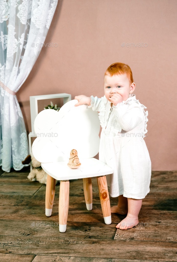 Little redhead baby girl celebrates first birthday anniversary. 1 year family party Professional  - Stock Photo - Images