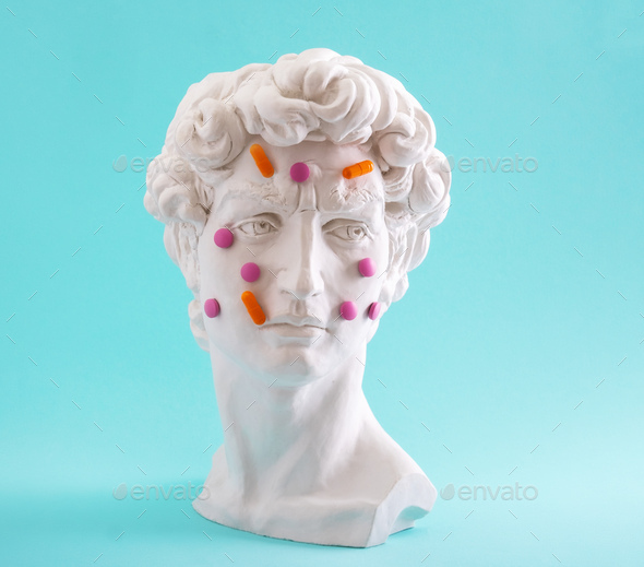David head statue with pills and tablet oh his face.  - Stock Photo - Images
