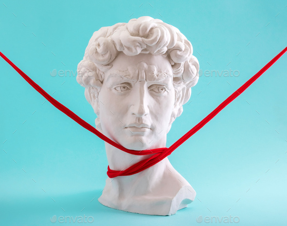 David head is an ancient statue with a throat rewound with a red thread. - Stock Photo - Images