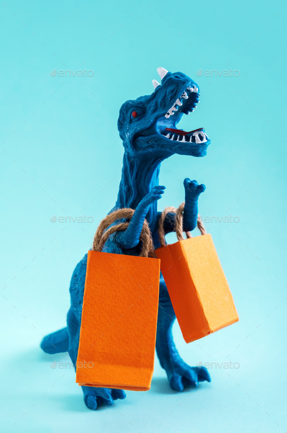 Cute clue dinosaur with orange shopping bags on blue background.