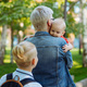 caucasian blond haired woman carry baby daughter. Schoolboy son looking at little sister - PhotoDune Item for Sale
