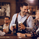 Happy waiter communicating with a guest while serving her beer in a pub. - PhotoDune Item for Sale