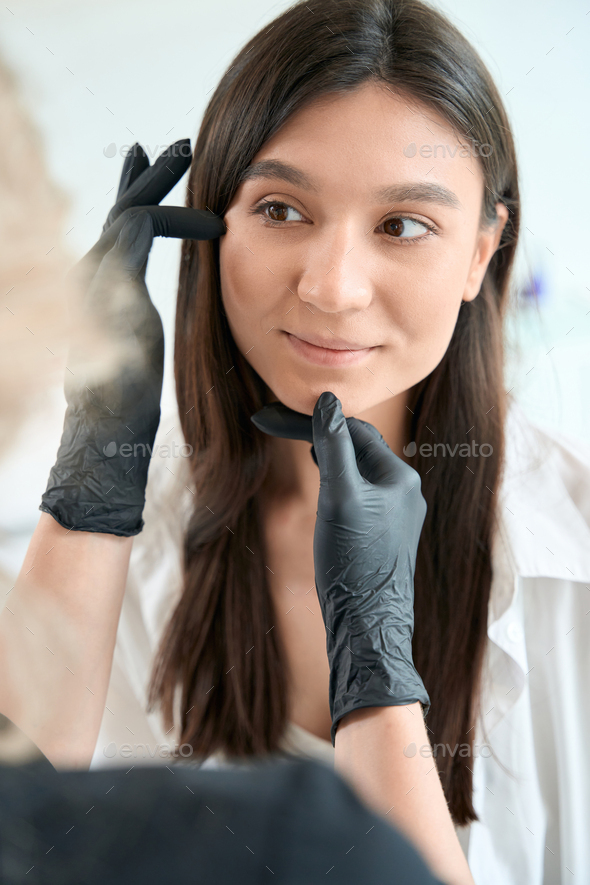 Dermatologist Examining Woman Face Before Skin Treatment Stock Photo By