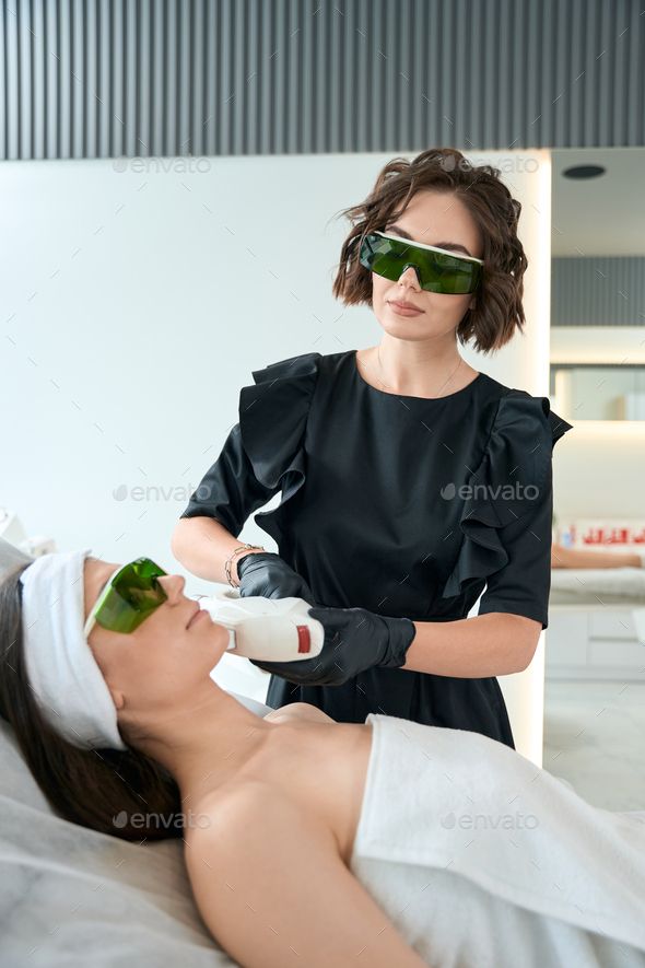 Adult female on laser hair removal procedure Stock Photo by svitlanah