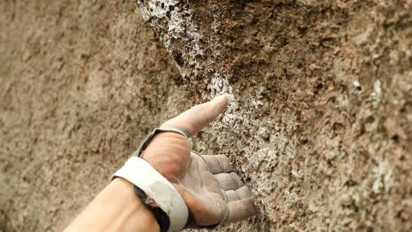 Close-up of the Hand of a Climber Taking a Rocky Ledge. alt