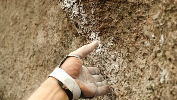 Close-up of the Hand of a Climber Taking a Rocky Ledge.