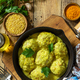 Meatballs with bulgur in sour cream and turmeric sauce in a cast-iron skillet.  - PhotoDune Item for Sale