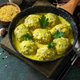 Meatballs with bulgur in sour cream and turmeric sauce in a cast-iron skillet.  - PhotoDune Item for Sale