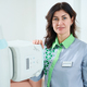 Beautiful woman in medical coat standing near the X-Ray machine - PhotoDune Item for Sale