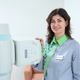 Happy female doctor standing beside hospital medical scanner - PhotoDune Item for Sale