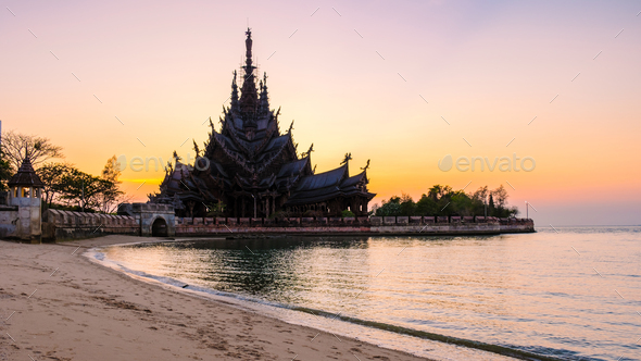 Sanctuary of Truth, Pattaya, Thailand, wooden temple by the ocean at sunset on the beach of Pattaya - Stock Photo - Images
