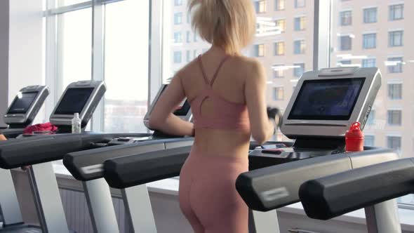 Young woman training on treadmill