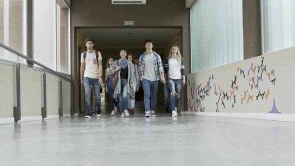 Group of college students walking in corridor