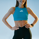 Close up of sporty slim young fitness woman standing, holding hands on waist on studio background - PhotoDune Item for Sale