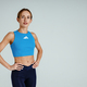 Strong attractive female fitness trainer in sportswear looking at camera on studio background - PhotoDune Item for Sale