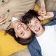 Portrait of happy woman with son, mother and boyfriend smiling and looking at camera lying together - PhotoDune Item for Sale