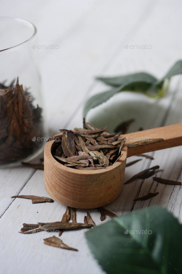 Dry tea leaves on spoon close up . - Stock Photo - Images