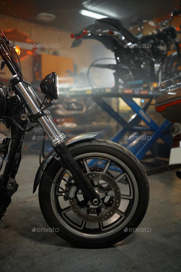 Motorcycles range in garage shop, repaired motorbikes ready for selling - Stock Photo - Images