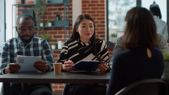 Diverse Group of Employees Talking to Applicant at Job Interview alt