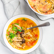 Tomato egg drop soup  with mushrooms and spring onions in a white bowl - PhotoDune Item for Sale