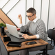 portrait of an office worker in a company sitting at a desktop with a laptop - PhotoDune Item for Sale