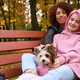 Two cheerful ladies spending time with their dog outdoors - PhotoDune Item for Sale