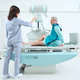 Female doctor preparing machine for medical scan of man knee - PhotoDune Item for Sale